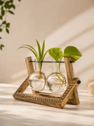 Premium double hydro pendulum vase with hand-carved mango wood frame and dual borosilicate glass planters, styled as elegant hydroponic desktop décor for home, office, gifting, and return gifts.
