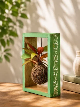 Handcrafted solid wood kokedama moss frame with hand-carved side design and hanging indoor plant for home décor and premium gifting.