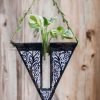 Handcrafted wooden wall hanging planter in a unique V-shaped design, perfect for adding a touch of nature-inspired elegance to your home decor. The planter features intricate carving details and a sturdy construction, providing a stylish and functional way to display your favorite indoor plants. Its artistic craftsmanship and natural wood finish effortlessly blend with various interior styles, bringing a refreshing and organic feel to any room."