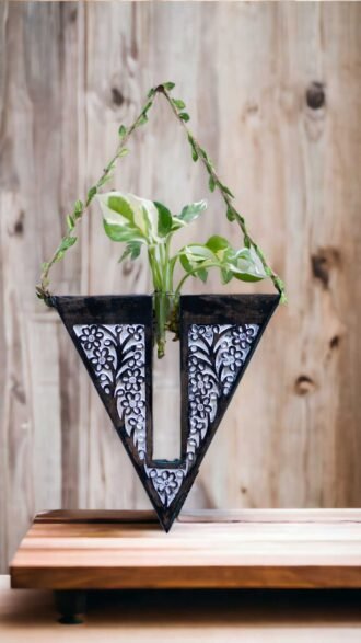 Handcrafted wooden wall hanging planter in a unique V-shaped design, perfect for adding a touch of nature-inspired elegance to your home decor. The planter features intricate carving details and a sturdy construction, providing a stylish and functional way to display your favorite indoor plants. Its artistic craftsmanship and natural wood finish effortlessly blend with various interior styles, bringing a refreshing and organic feel to any room."