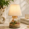 Glass lamp terrarium with succulent plants and fabric lampshade decorative indoor table lamp for modern home décor.