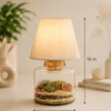 Glass lamp terrarium with succulent plants and fabric lampshade decorative indoor table lamp for modern home décor.
