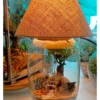 Bell jar lamp terrarium with plants and moss by Wildroots.