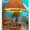 Bell jar lamp terrarium with plants and moss by Wildroots.