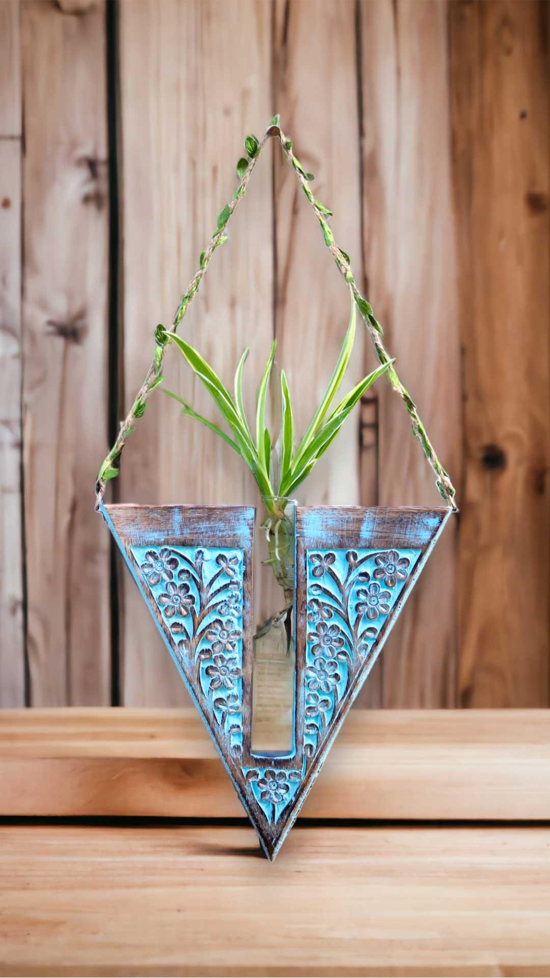Handcrafted wooden wall hanging planter in a unique V-shaped design, perfect for adding a touch of nature-inspired elegance to your home decor. The planter features intricate carving details and a sturdy construction, providing a stylish and functional way to display your favorite indoor plants. Its artistic craftsmanship and natural wood finish effortlessly blend with various interior styles, bringing a refreshing and organic feel to any room."