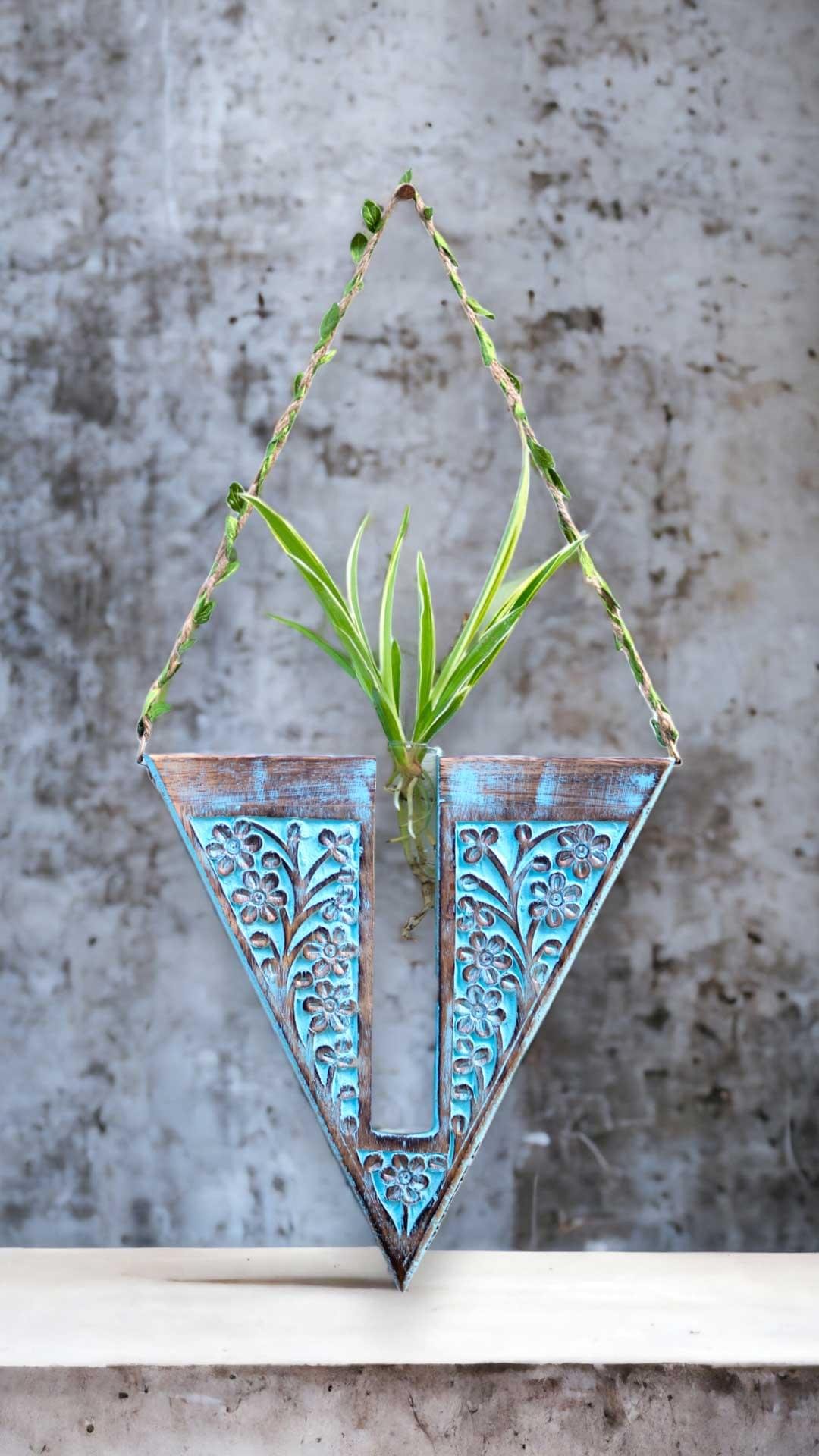 Handcrafted wooden wall hanging planter in a unique V-shaped design, perfect for adding a touch of nature-inspired elegance to your home decor. The planter features intricate carving details and a sturdy construction, providing a stylish and functional way to display your favorite indoor plants. Its artistic craftsmanship and natural wood finish effortlessly blend with various interior styles, bringing a refreshing and organic feel to any room."