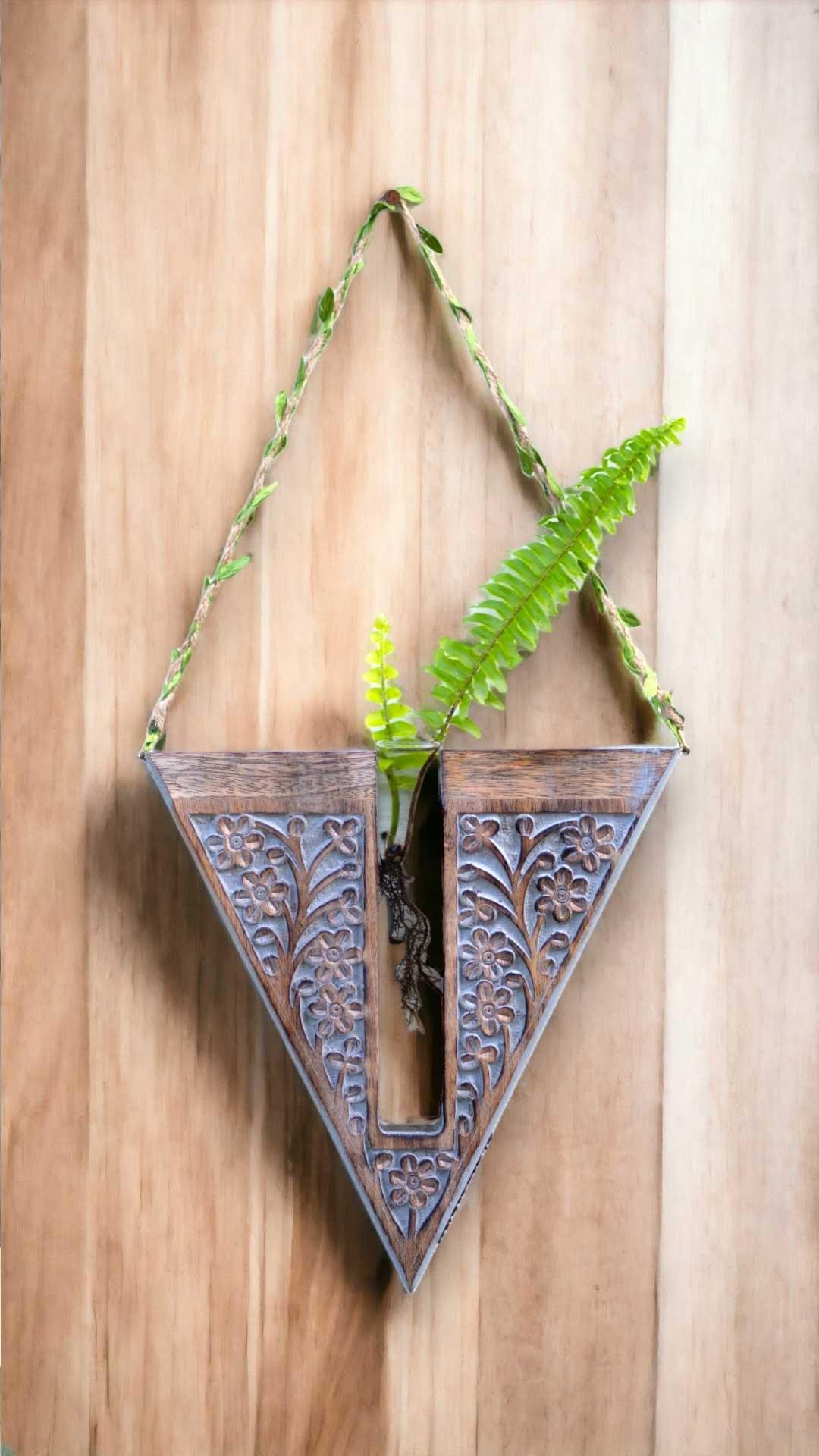 Handcrafted wooden wall hanging planter in a unique V-shaped design, perfect for adding a touch of nature-inspired elegance to your home decor. The planter features intricate carving details and a sturdy construction, providing a stylish and functional way to display your favorite indoor plants. Its artistic craftsmanship and natural wood finish effortlessly blend with various interior styles, bringing a refreshing and organic feel to any room."