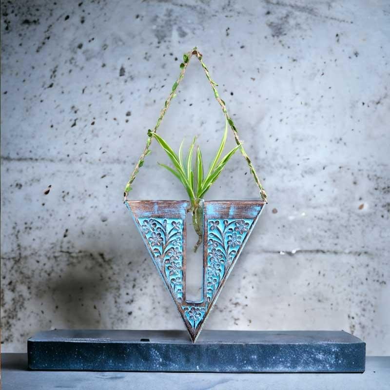 Handcrafted wooden wall hanging planter in a unique V-shaped design, perfect for adding a touch of nature-inspired elegance to your home decor. The planter features intricate carving details and a sturdy construction, providing a stylish and functional way to display your favorite indoor plants. Its artistic craftsmanship and natural wood finish effortlessly blend with various interior styles, bringing a refreshing and organic feel to any room."