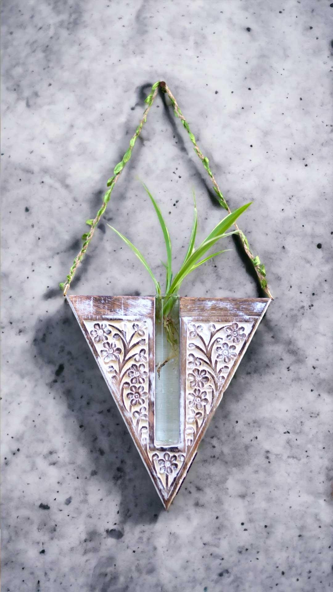 Handcrafted wooden wall hanging planter in a unique V-shaped design, perfect for adding a touch of nature-inspired elegance to your home decor. The planter features intricate carving details and a sturdy construction, providing a stylish and functional way to display your favorite indoor plants. Its artistic craftsmanship and natural wood finish effortlessly blend with various interior styles, bringing a refreshing and organic feel to any room."