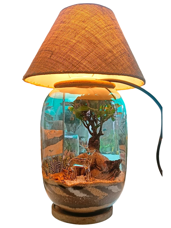 Bell jar lamp terrarium with plants and moss by Wildroots.